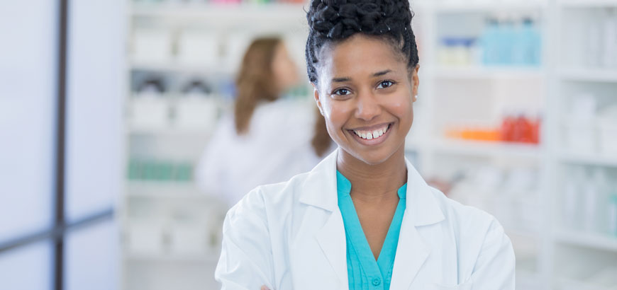 Black female pharmacy tech standing and smiling