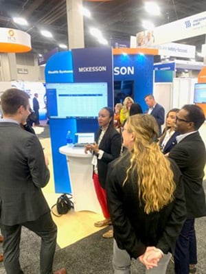 Nicole Mayo standing at a McKesson booth at a convention