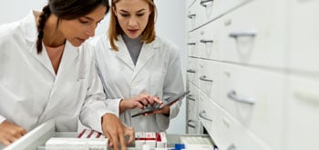 Two lab workers look at something together