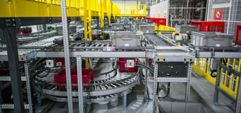 Interior of manufacturing factory featuring assembly line belts and mechanics<br>  