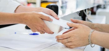 Close up of two hands exchanging a package between them