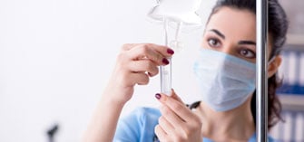 A nurse holding an IV bag