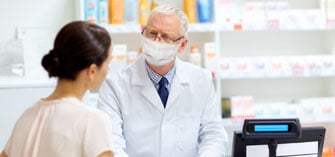 A pharmacist speaking to a customer