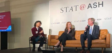 Panel discussion at STAT@ASH event with three people on stage.