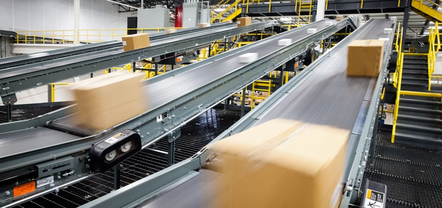 Assembly line conveyor belts moving boxes through a distribution facility