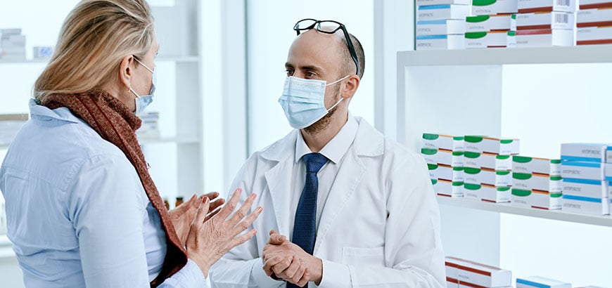 A customer speaking with a pharmacist