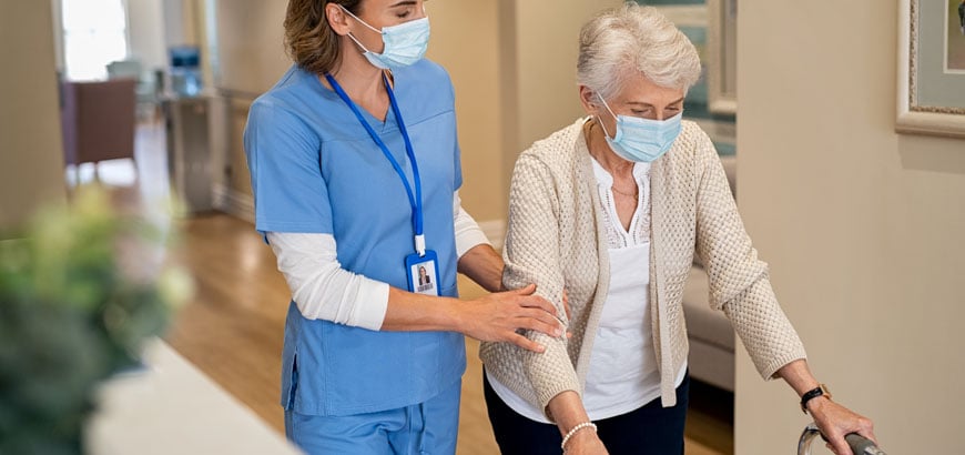 <span>Nurse helping senior patient walk</span>