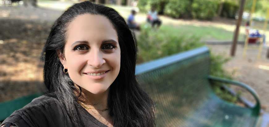 Closeup of Ferial Scott sitting on a bench