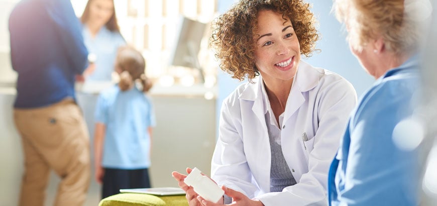 <span>A female pharmacist sits with a senior female patient in the pharmacist consultation area and discusses her prescription and choice of medication  </span>