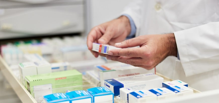 Close up view of a pharmacist holding medication