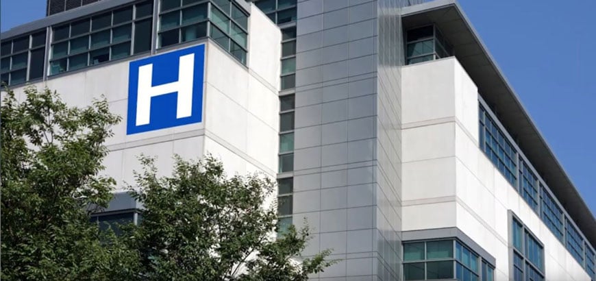 Exterior image of a hospital building with a large H on the side