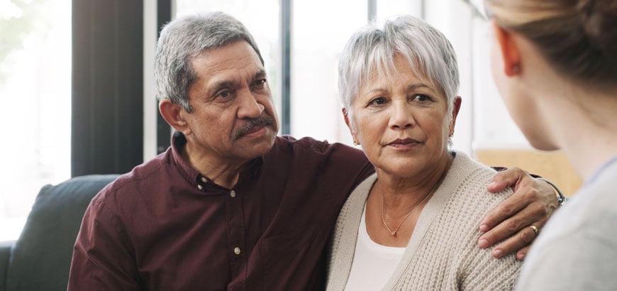 <span>Husband and wife talking with healthcare worker</span>