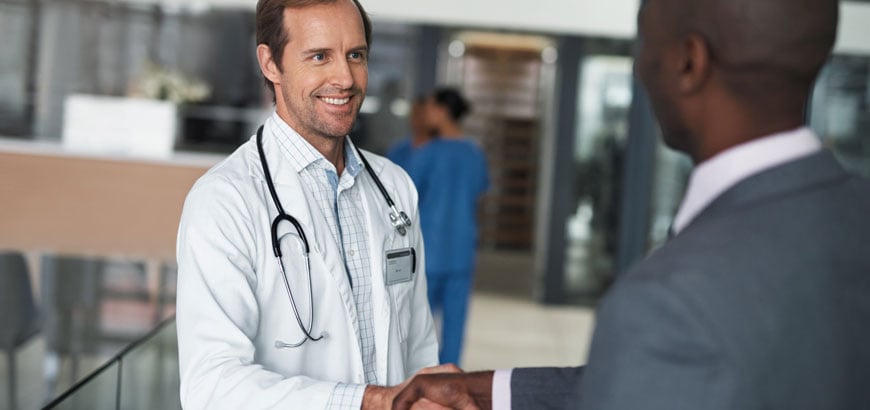 <span>A healthcare provider shaking hands with hospital administer</span>