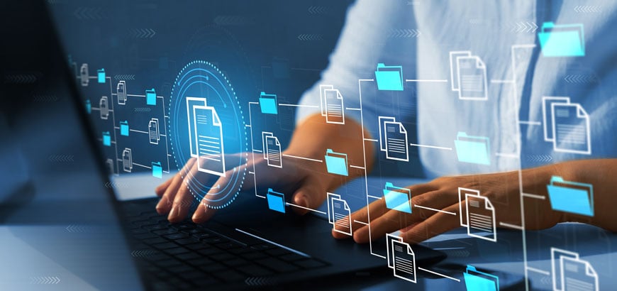 Close up of hands typing on a laptop keyboard while symbols representing documents and folders float over the image