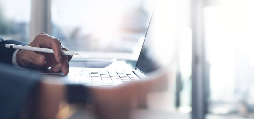 Close up image of hands typing on a keyboard