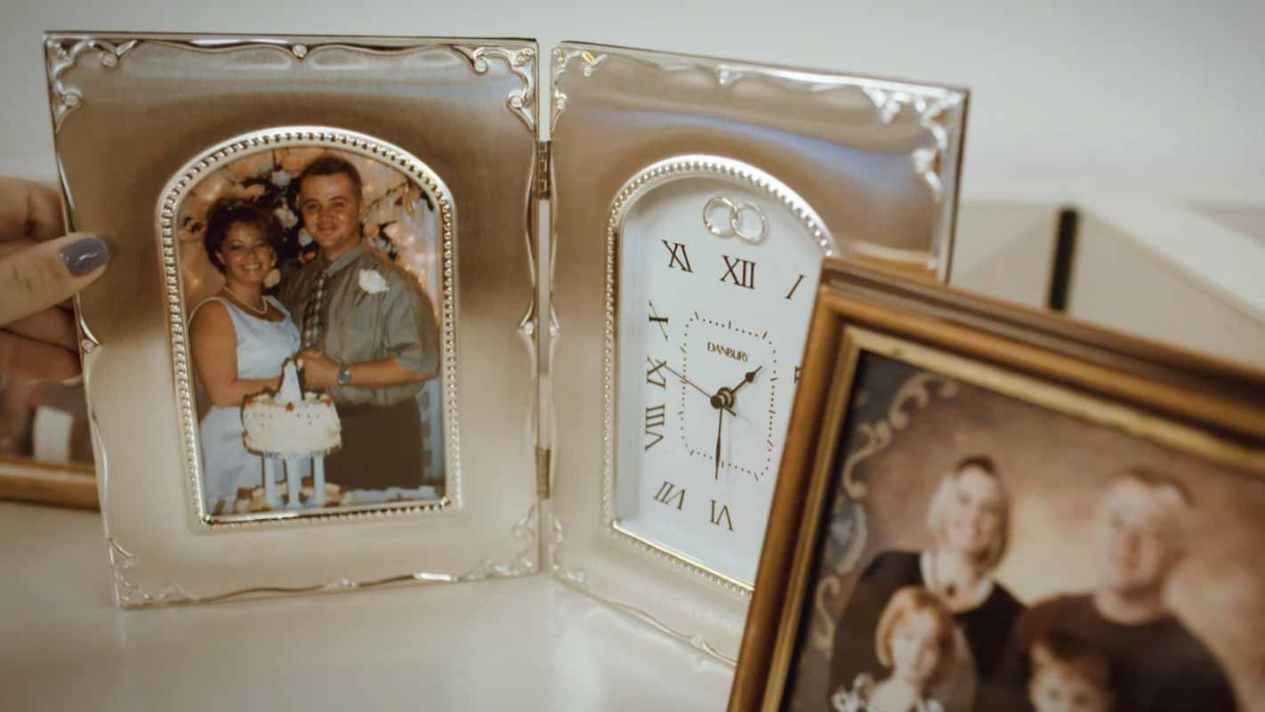 Framed family photographs on a mantle