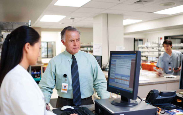 Two pharmacists looking at a computer screen