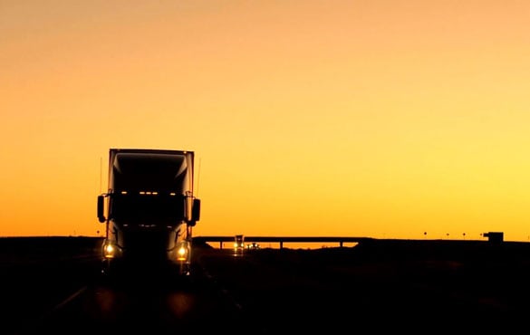 Sunset with a truck silhouette in the foreground