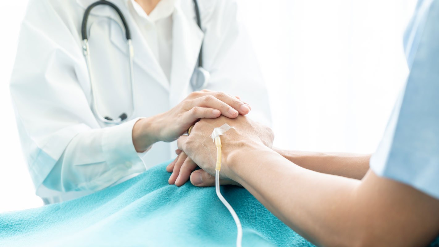 A doctor holding a patient's hands