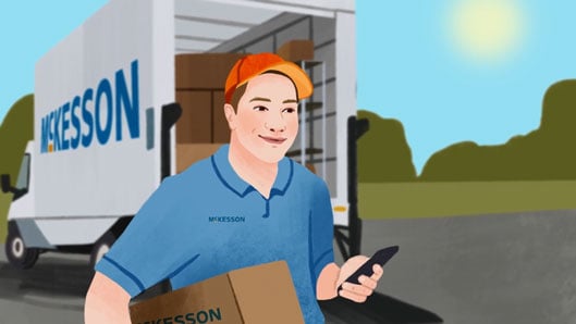 A McKesson delivery person walks in front of a McKesson truck