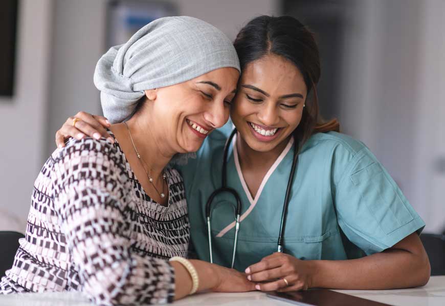 A cancer patient and a doctor embrace each other