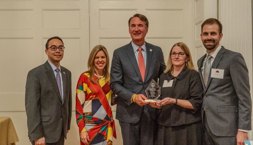 <span>Med-Surg Senior Director of Project Management Tammy Cross (second from left) and Senior Director of Pricing Operations and Analytics Tom Niemas (far right) receive a 2023 Volunteerism and Community Service Award from Virginia Governor Glenn Youngkin (center)</span>