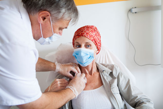 A doctor talking to an oncology patient in a hospital