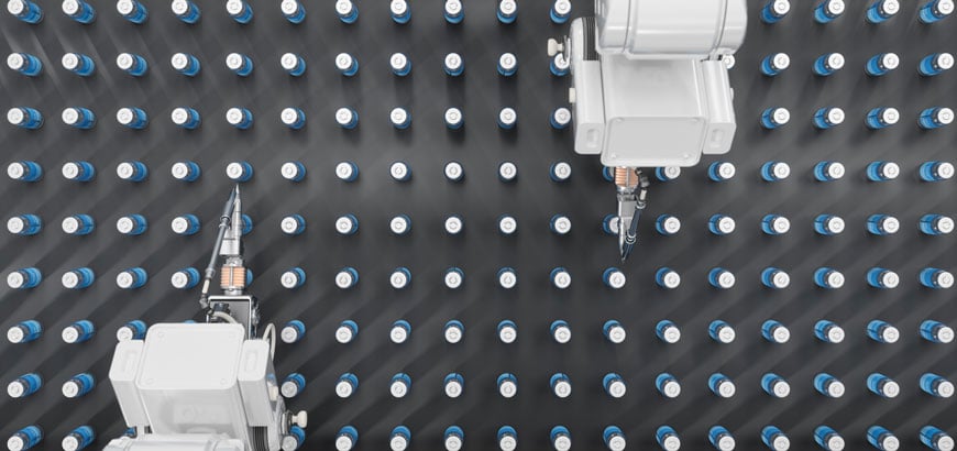 Robotic arms work over a grid of numerous identical bottles on a dark surface.