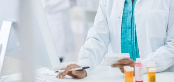 Closeup of a pharmacist holding a drug package