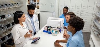 pharmacy team talking over table